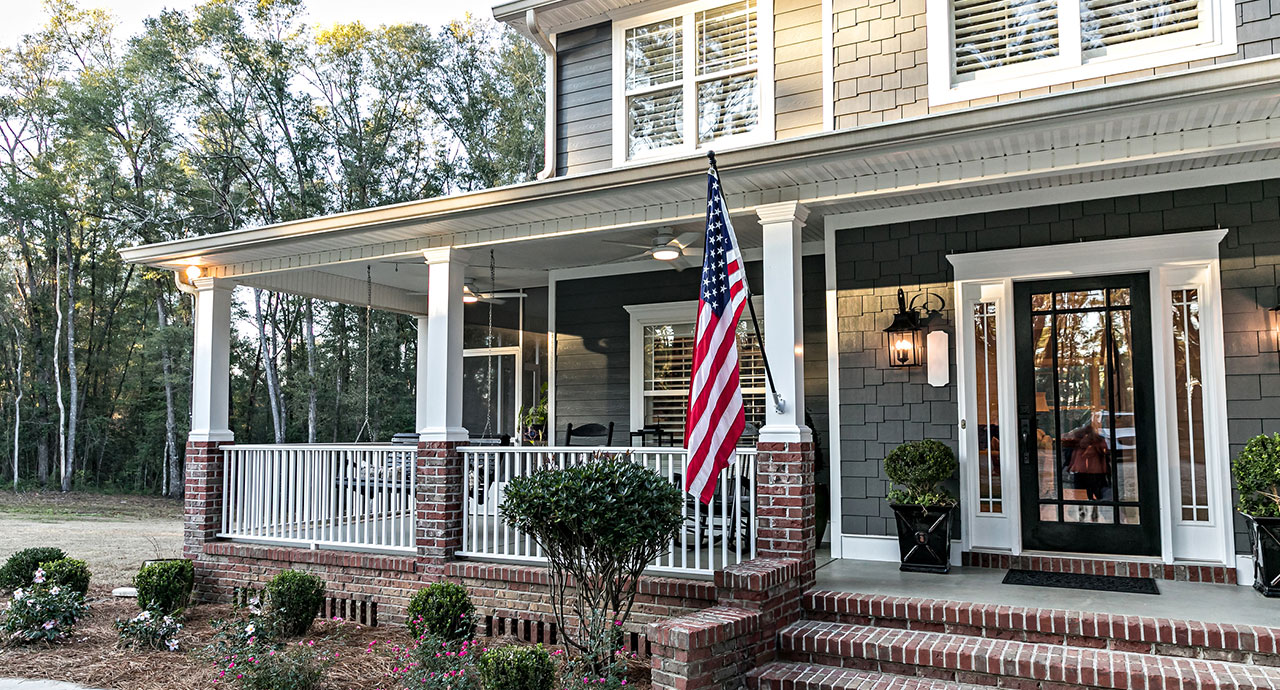 Beautiful Home With an the American Flag on the Porch